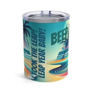 Puede incluir: Un vaso de color turquesa y azul con una escena de playa y el texto "I took the leap! Leap year baby! Beep"