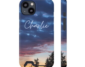 May include: A phone case with a sunset sky background and the name "Charlie" written in white script. The case is designed for an iPhone with a camera bump.