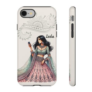 May include: A white phone case featuring an illustration of a woman in traditional Indian attire, holding a phone. The design includes a floral pattern and the name "Leela". The case has a black border and a side view is also shown.