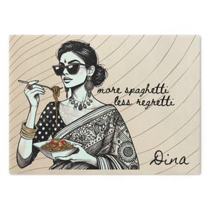 May include: A black and white illustration of a woman wearing sunglasses and a patterned sari, eating spaghetti from a bowl. The text "more spaghetti less regretti" and the name "Dina" are written below the woman.