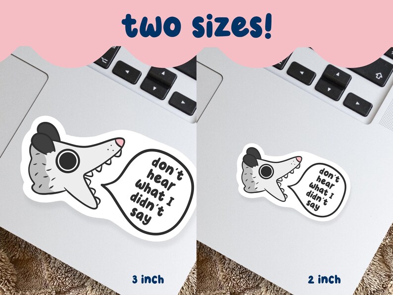 May include: Two stickers featuring a cartoon opossum with the text "don't hear what I didn't say." One sticker is 3 inches, the other is 2 inches. The opossum is gray, white, and black, with a pink nose and a speech bubble.