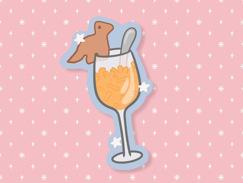 May include: A whimsical sticker featuring a cartoon cocktail in a wine glass, filled with orange liquid and ice. A brown cookie shaped like a creature sits on the rim, with a spoon inside. The sticker has a blue outline and is set against a pink background.
