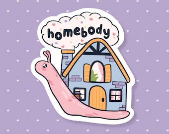 May include: A whimsical sticker featuring a cartoon snail with a house-shaped shell. The house is blue with a yellow roof and door, and the word "homebody" is written above in a cloud. The snail is pink.