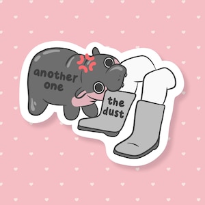 May include: A sticker featuring a cartoon hippo with an angry expression and the text "another one." The hippo is kicking a pair of gray boots with the text "the dust." The background is pink with white hearts.