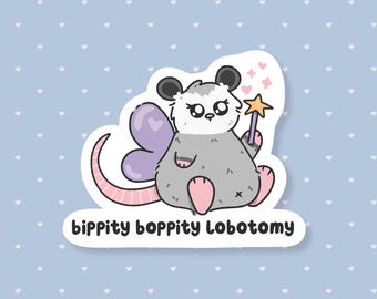 May include: A sticker featuring a cartoon opossum with fairy wings, holding a star wand. The opossum is gray with pink accents and black ears. The sticker has the text "bippity boppity Lobotomy" in a black, rounded font.