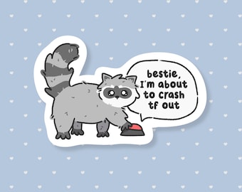 May include: A sticker featuring a cartoon raccoon with a gray body, black mask, and striped tail. The raccoon is reaching for a red button. A speech bubble says, "bestie, I'm about to crash tf out."