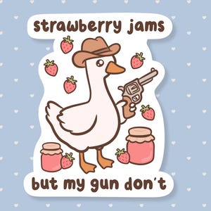 May include: A sticker featuring a cartoon goose wearing a cowboy hat and holding a revolver. The text "strawberry jams but my gun don't" is displayed. Strawberries and jars of jam are also illustrated.