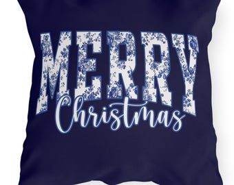 May include: A square navy blue decorative pillow with the words "MERRY Christmas" in white. The letters of "MERRY" are filled with a blue floral pattern. The word "Christmas" is in a cursive font.