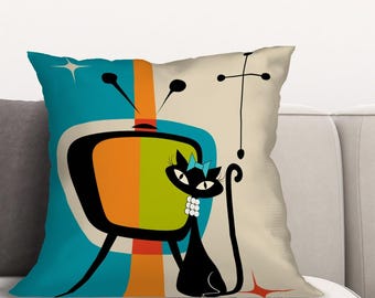 May include: A throw pillow with a retro design featuring a black cat in front of a stylized television set with orange, green, and blue accents.