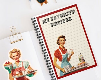 May include: A red spiral bound notebook with the words "My Favorite Recipes" on the cover. The cover features a vintage illustration of a woman in a red and white polka dot dress and blue apron holding a plate of food.
