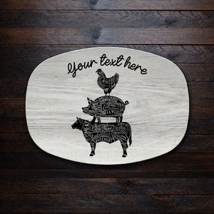 May include: White oval serving platter with a black and white illustration of a chicken, pig, and cow, each labeled with different cuts of meat. The text "Your text here" is written above the animals.