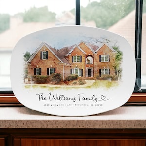 May include: A white oval serving platter with a watercolor painting of a two-story brick house. The text "The Williams Family" and "6840 WILDWOOD LANE | TECUMSEH, NE 68450" is printed below the house.