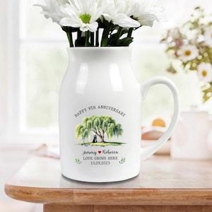 May include: White ceramic vase with a handle, filled with white flowers. The vase is decorated with a tree illustration and the text "HAPPY 9TH ANNIVERSARY". Below the tree are the names "Jimmy ❤️ Rebecca" and the date "10.09.2025".