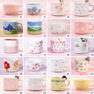 May include: A selection of ceramic mugs in various colours and designs. Some mugs feature floral patterns, paw prints, or text. Others have decorative elements like small animal figurines. Measurements are not available.