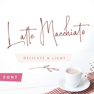 May include: A digital graphic featuring the dark red handwritten text Latte Macchiato, the words DELICATE & LIGHT in a light pink banner, and the word FONT in a pink banner. A white coffee cup on a saucer sits on a brown slatted mat.