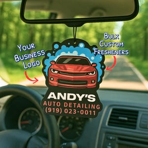May include: Black car air freshener with a red sports car graphic, blue bubbles, and the text "Bulk Custom Fresheners." The bottom of the freshener reads "Andy's Auto Detailing (919) 023-0011."