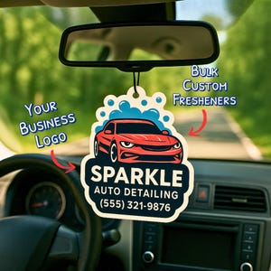 May include: A car air freshener with a red sports car graphic and the text "SPARKLE AUTO DETAILING (555) 321-9876". The freshener is hanging from a car's rearview mirror, with the text "Bulk Custom Fresheners" and "Your Business Logo".