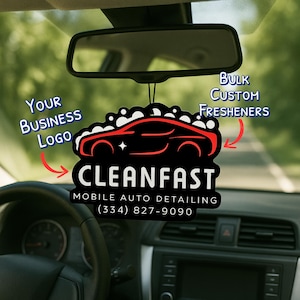 May include: Black car air freshener with a red car outline and the text "CLEANFAST MOBILE AUTO DETAILING (334) 827-9090." The freshener hangs from a car's rearview mirror. Text on the freshener says "Bulk Custom Fresheners" and "Your Business Logo."