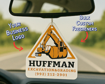 May include: A triangular car air freshener with a construction vehicle graphic. The air freshener has a white background with an orange border and a yellow excavator. The text "HUFFMAN EXCAVATION & GRADING (992) 212-2901" is printed on the bottom.