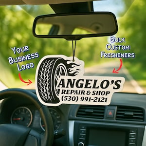 May include: Custom car air freshener with a tire graphic and the text "ANGELO'S REPAIR & SHOP (530) 991-2121". The freshener is hanging from a car's rearview mirror. The image also includes the text "Your Business Logo" and "Bulk Custom Fresheners".