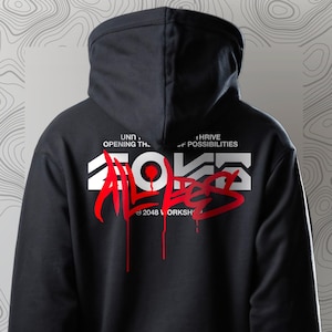 Op de afbeelding: Zwart hoodie met een rode grafische print die "2048 ALL EYES" zegt met de tekst "UNIT, OPENING THE... THRIVE OF POSSIBILITIES" erboven en "2048 WORKSH" eronder.