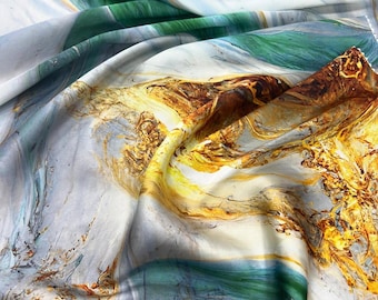 May include: A close-up of a fabric with a marbled design. The fabric features swirls of white, blue, green, and gold. The colors blend together to create an abstract, artistic pattern. The fabric is likely used for clothing or home decor.