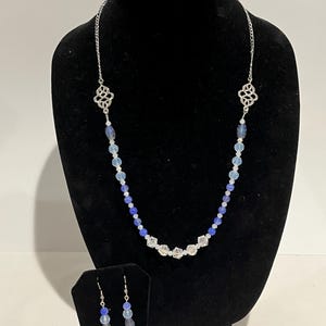 Beaded necklace 24” and earrings 2” set. Blue glass and faceted crystal beads with silver tone accents.