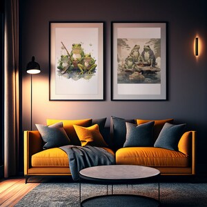 May include: Two framed watercolor paintings of frogs. The painting on the left shows three frogs sitting on a log. The painting on the right shows four frogs sitting on a rock in a pond. The paintings are hanging on a dark gray wall above a yellow couch.