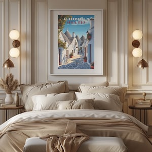 May include: A vintage travel poster featuring a picturesque street scene in Alberobello, Puglia, Italy. The poster depicts white-washed buildings with conical roofs, a bicycle, and a cobblestone street.