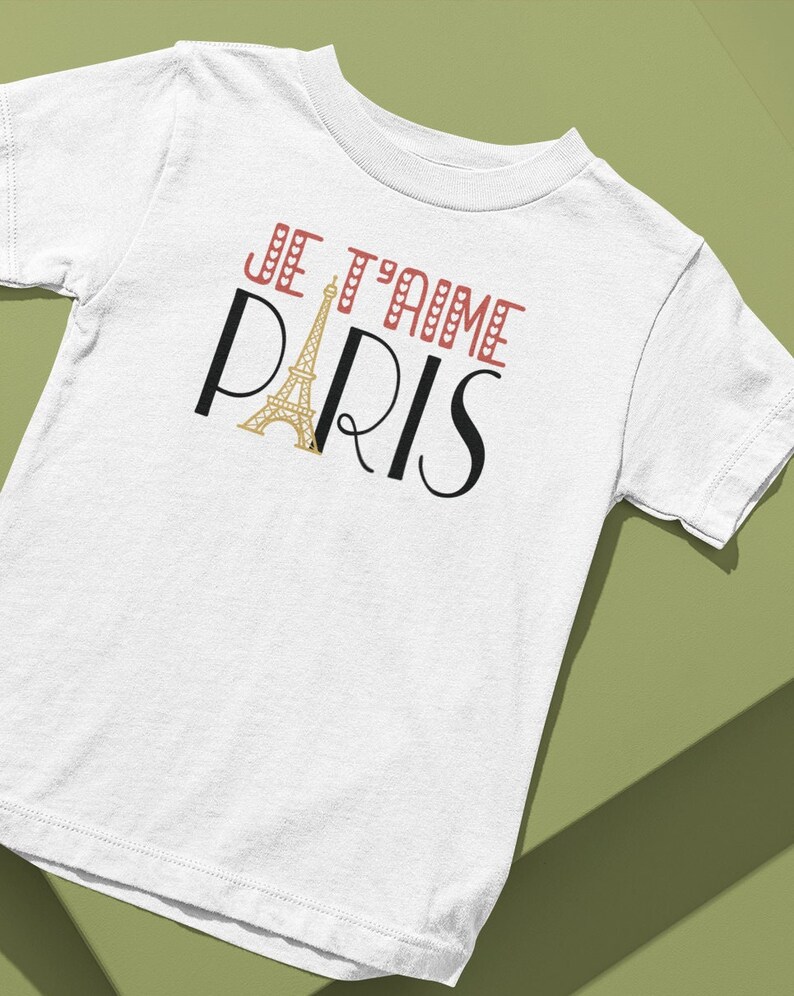 A tshirt that says "Je T'aime Paris". The A in "Paris" is replaced with a graphic of the Eiffel Tower.