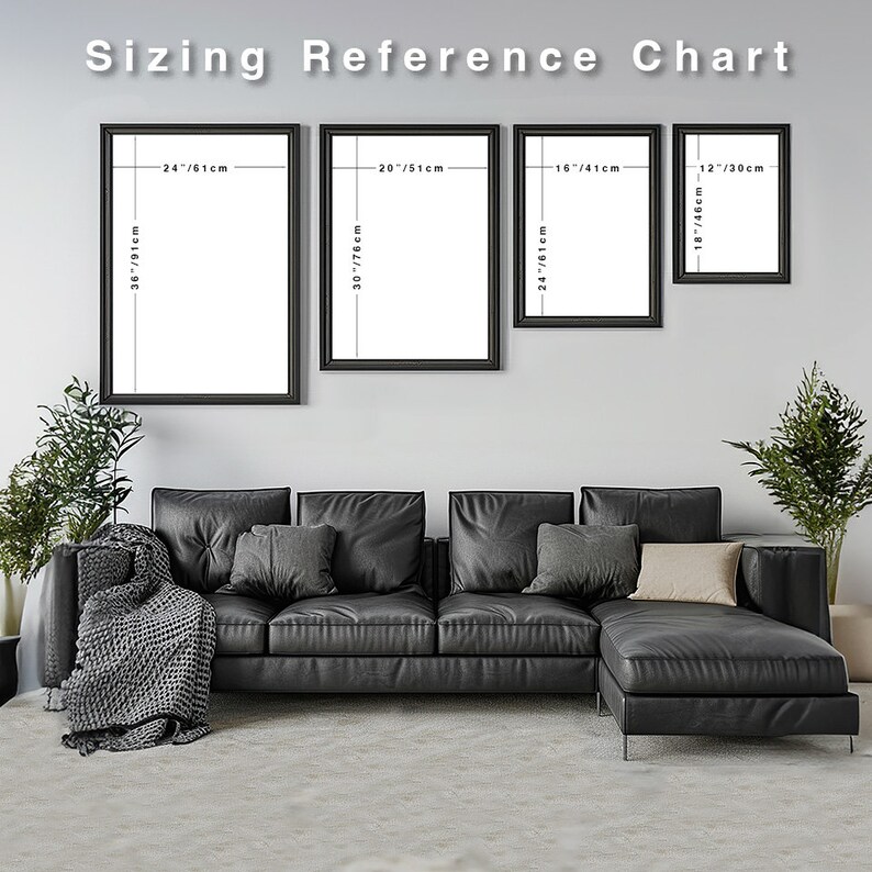 May include: A white wall with four black framed pictures of different sizes. The pictures are arranged in a row from left to right. The pictures are labeled with their dimensions in inches and centimeters. The pictures are hanging above a black leather sectional sofa with gray throw pillows and a gray throw blanket.