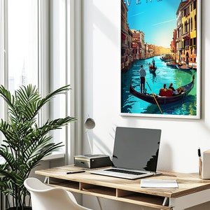 May include: A framed poster with a colorful illustration of a canal in Venice, Italy. The poster features the word "VENEZIA" in a stylized font at the top. Gondolas are seen in the canal with people in them.
