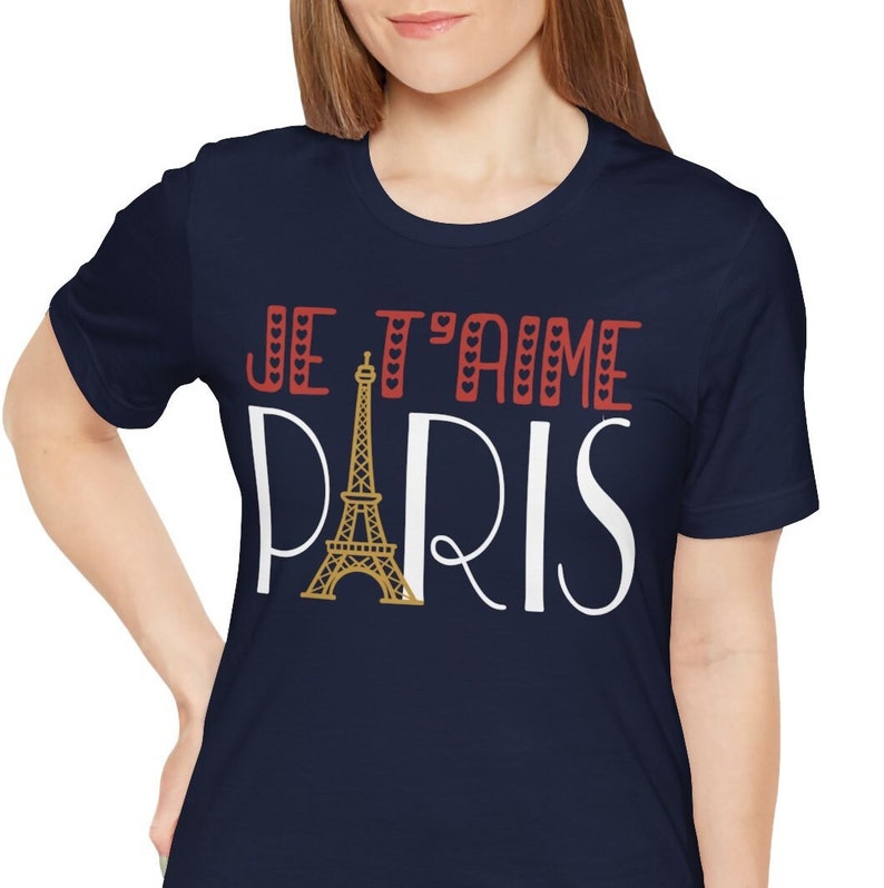 A woman wearing a tshirt that says "Je T'aime Paris". The A in "Paris" is replaced with a graphic of the Eiffel Tower.