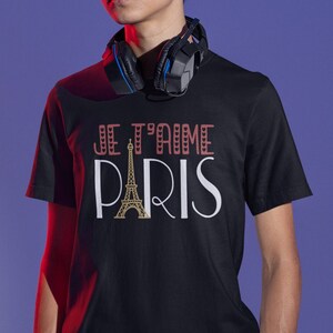 A male youth wearing a black tshirt that says "Je T'aime Paris". The A in "Paris" is replaced with a graphic of the Eiffel Tower.