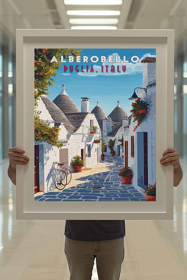 May include: A vintage travel poster featuring a colorful illustration of a street in Alberobello, Puglia, Italy. The street is lined with white buildings with conical roofs, and there are potted plants and a bicycle in the foreground.