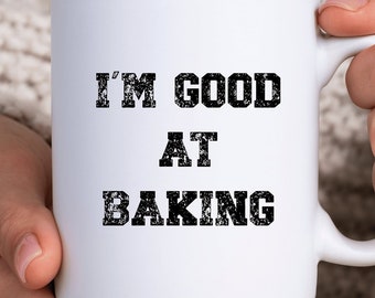 May include: White ceramic mug with black text that reads "I'm good at baking".