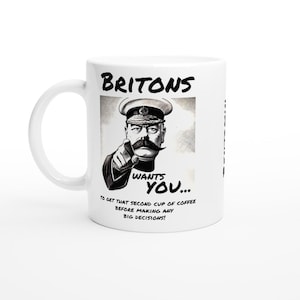 May include: White ceramic mug featuring a black and white image of a man in military uniform. The text "BRITONS WANTS YOU... TO GET THAT SECOND CUP OF COFFEE BEFORE MAKING ANY BIG DECISIONS!" is printed on the mug.