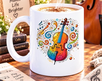 May include: A white ceramic mug featuring a colorful, stylized illustration of a cello surrounded by musical notes and swirling patterns. The mug contains a steaming hot beverage. The design includes vibrant shades of red, orange, yellow, and blue.