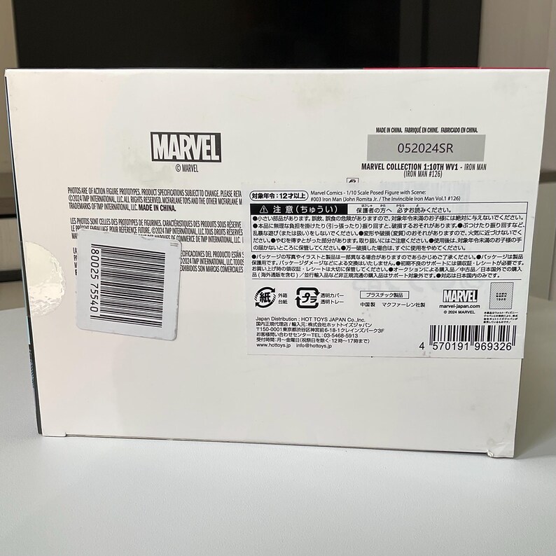 May include: A Marvel Iron Man action figure box. The box is white with the Marvel logo and product information. The text includes "Marvel Collection 1/10th WV1 - Iron Man (#126)". The box also has Japanese text and a barcode.