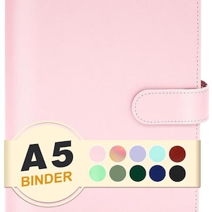 May include: A light pink A5 binder with a smooth finish and a side strap closure. A horizontal band across the front displays the text A5 BINDER in black and orange, accompanied by a grid of ten small colored circles representing various color options.