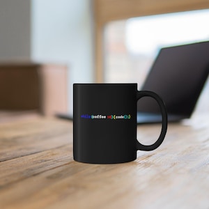 May include: A black ceramic mug featuring the colorful programming code text while (coffee > 0){code();}. The mug has a standard cylindrical shape with a curved handle on the right side, displaying the text in blue, white, red, and yellow.