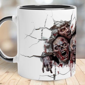 May include: White ceramic coffee mug with a black rim and handle. The mug features a graphic of three zombie heads breaking through a cracked wall, with blood splatters.