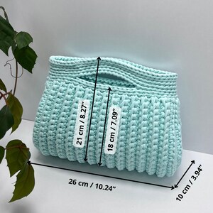 Handmade crochet clutch bag featuring a modern ribbed texture and minimalist design. Stylish crocheted purse made from chunky yarn, perfect for everyday wear, special occasions, and evening outings. The elegant rectangular shape adds a contemporary touch to any outfit. Detailed crochet stitches create a unique texture that makes this bag both fashionable and eye-catching.