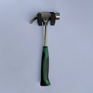 May include: A silver hammer with a black and green handle. The hammer has a rubber grip.