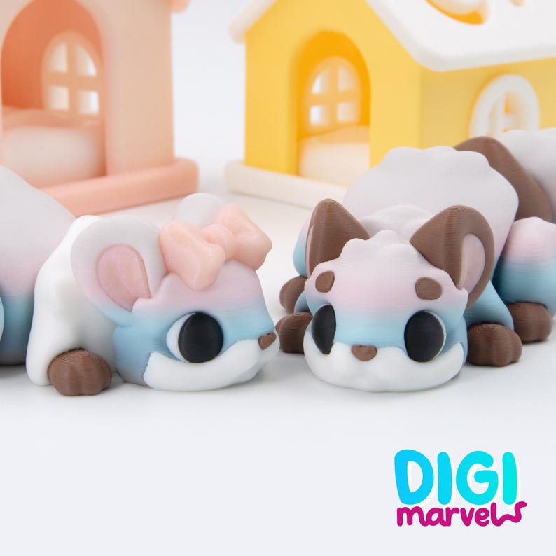 K&ouml;nnte beinhalten: Zwei kleine, stilisierte Tierfiguren mit Farbverlauf in Wei&szlig;, Rosa und Blau. Eine Figur hat eine rosa Schleife auf dem Kopf. Beide haben gro&szlig;e schwarze Augen und braune Akzente. Der Text "DIGI marvels" befindet sich in der unteren rechten Ecke.