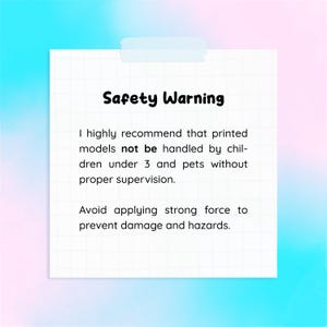 May include: A white sticky note with the text "Safety Warning" in bold black letters. The note recommends that printed models not be handled by children under 3 and pets without supervision. It also advises against applying strong force.