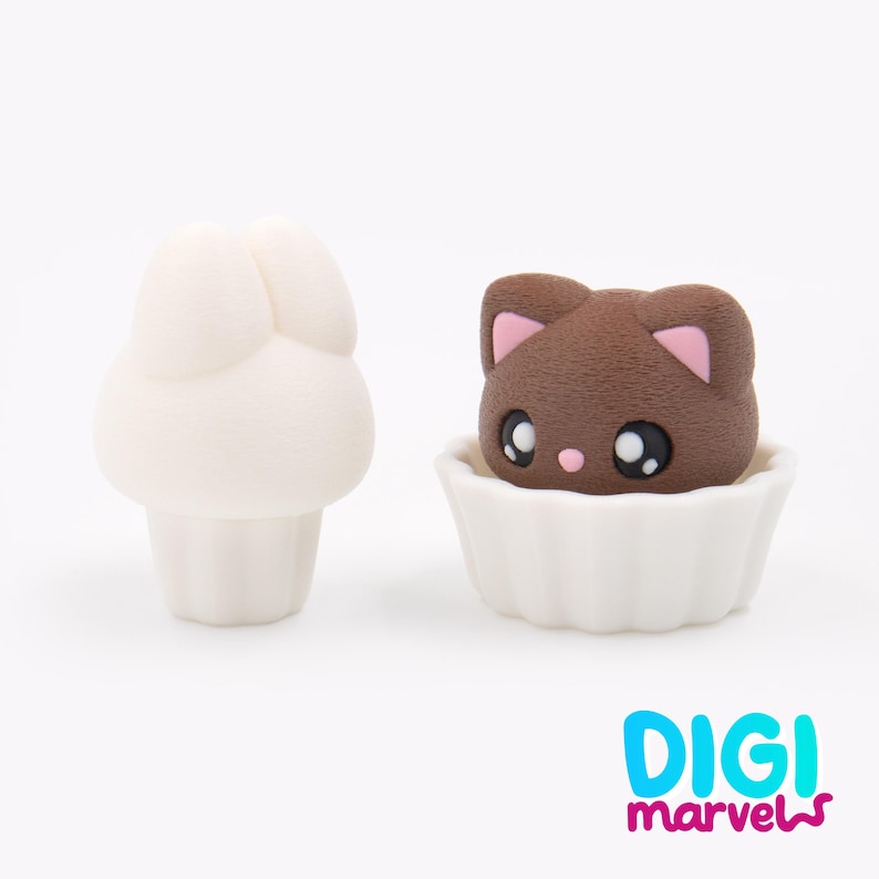 May include: Two small, white, mushroom-shaped figurines and a brown cat-shaped figurine in a white cupcake holder. The cat has pink ear accents and large, expressive eyes. The logo "DIGI marvels" is in the bottom right corner.