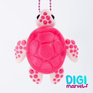 May include: A pink and white turtle pendant with a matching chain. The turtle has a bright pink shell and dotted accents on its flippers and head. The pendant is a cute, whimsical accessory.