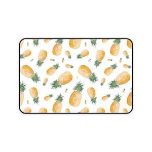 May include: A white background with a repeating pattern of yellow pineapples with green tops.