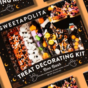 May include: A Halloween-themed treat decorating kit with the text "SWEETAPOLITA TREAT DECORATING KIT Boo Bash". The kit includes sprinkles, candy shapes, and sugar. The box is black with orange accents and a ghost and crescent moon design.